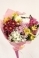 Цветно съчетание от свежи 4 алтромерии и 3 хризантеми, обгърнати в нежност от розова текстилна хартия